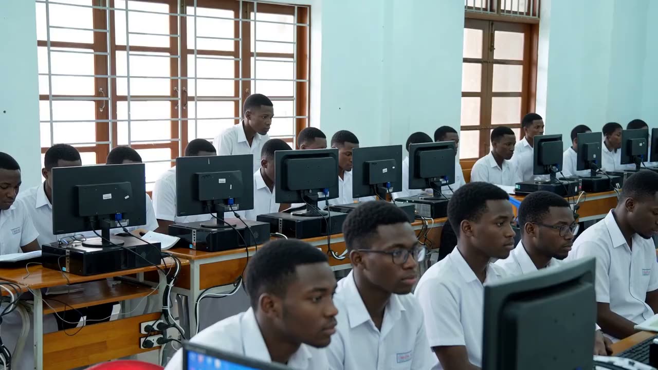 A full computer lab of students at their monitors during a lesson.
